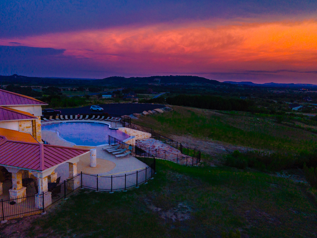 Sunset photo of the community pool, club house, and fitness center