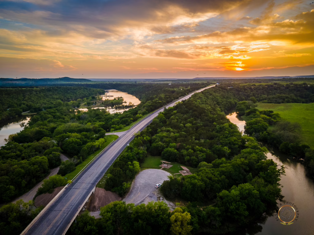 Sunset aerial drone photograph of the Highway 16 bridge crossing Rock Creek near Possum Kingdom Lake in Palo Pinto County, Texas.