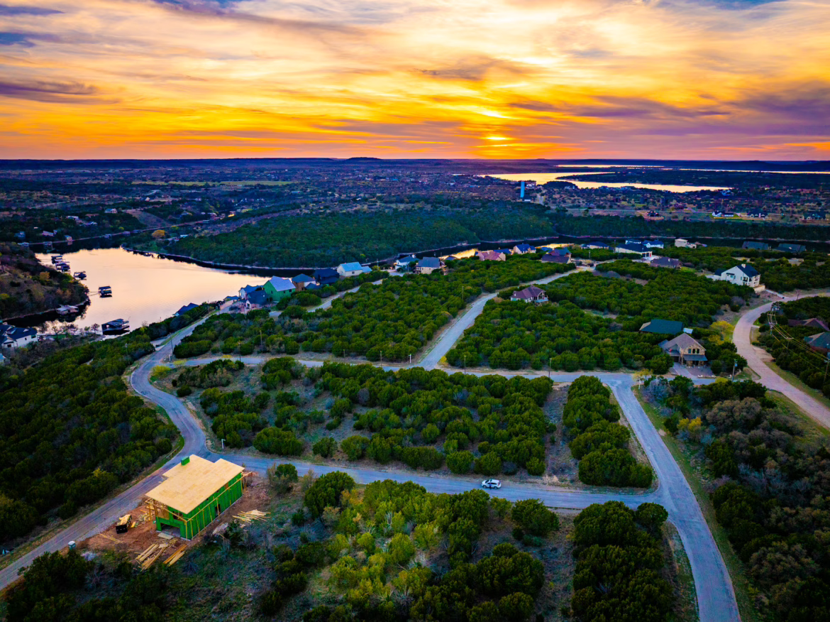 Drone view of empty lots in The Cliffs at Possum Kingdom Lake during sunset showing large inventory of available land